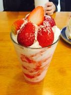 dessert in a glass with cream and strawberries