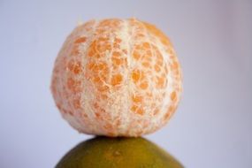 peeled mandarin in mirror image