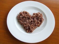 rice in the shape of a heart on a plate