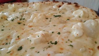 pizza with cheese and herbs