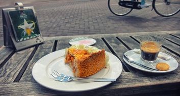 cake and coffee on wooden table outdoor, netherlands, amsterdam