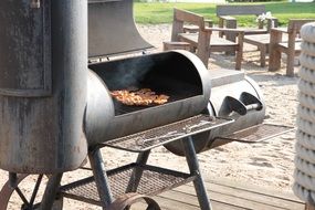 pieces of meat are fried on the barbecue for party