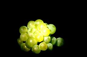 green grapes close up at black background