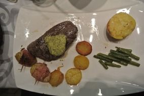 steak with sauce and vegetables