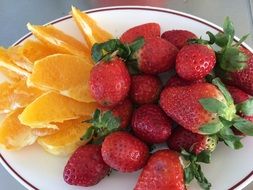 strawberries and orange slices on a plate