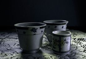 teacups on the table in the dark