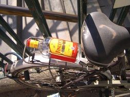 empty bottle of booze on a bicycle