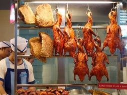 Roasted pork duck on a metal construction
