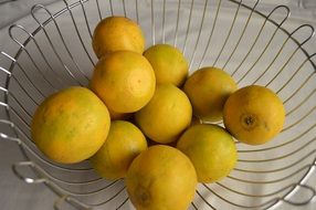 yellow lemons in metal basket