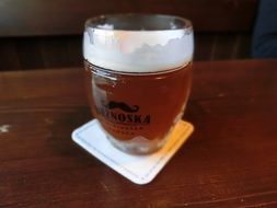 a glass of beer is on the table