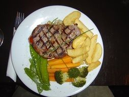 meat steak with potatoes and vegetables