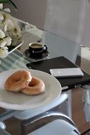 cup of coffee next to donuts