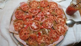 pizza with red tomatoes on a plate