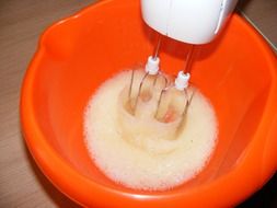 Mixer beats foam in a bowl