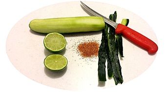 peeled and sliced cucumber on a board