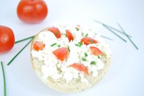 top view on a sandwich with cream cheese and slices of red tomato