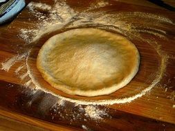 Pizza dough on a wooden board