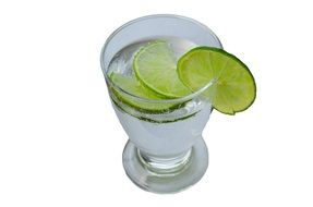 glass of mineral water and slice of lemon on white