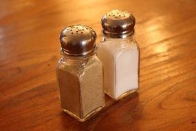 glass salt and pepper shaker on a wooden table