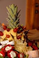 decorated of cheese plate with using pineapple and grapes