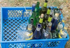 empty glass bottles of various drinks