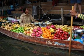 fruit trading boat on channel, thailand