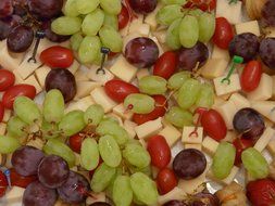 grapes tomatoes and cheese plate close-up