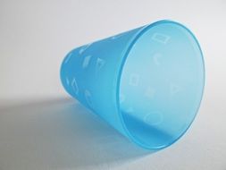 empty inverted blue plastic cup