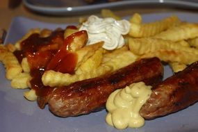 french sausage with french fries and sauce