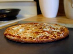 just finished pizza and drink on table