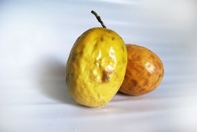 two yellow passion fruit