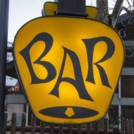 yellow sign for a bar