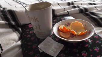 medications and mug on bed