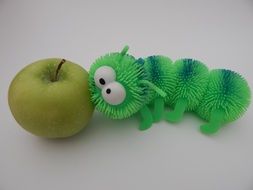green centipede near a green apple