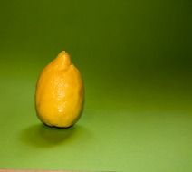 yellow sour lemon on the green background