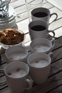 cups with coffee on a wooden table