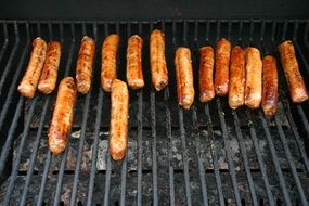 grilled sausages on the grill in the evening