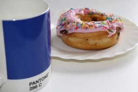 breakfast, blue mug and donut on table