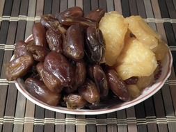dried peaches and sweet dates on a plate