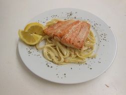 pasta with salmon on a white plate