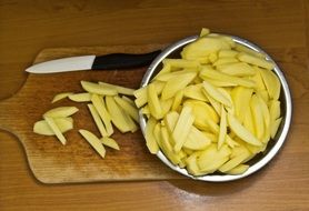 Cut raw french fries and knife