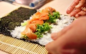 cooking of sushi with rice and salmon