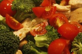 Organic fresh healthy salad made of tomatoes,broccolies and bread close-up