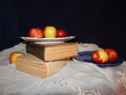 Apple on the plates and books