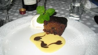 chocolate cake decorated with cream and mint