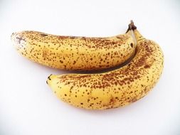 ripe bananas on a white surface