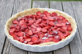 sweet cake with strawberries on a wood