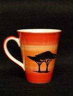 cup with the african landscape on black background