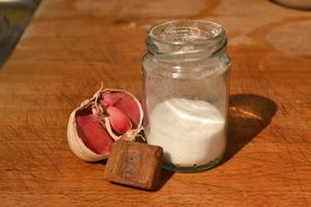 garlic and salt on a wooden board