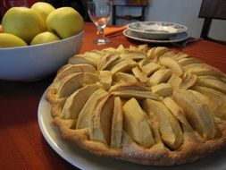 apple pie on a white plate on the table